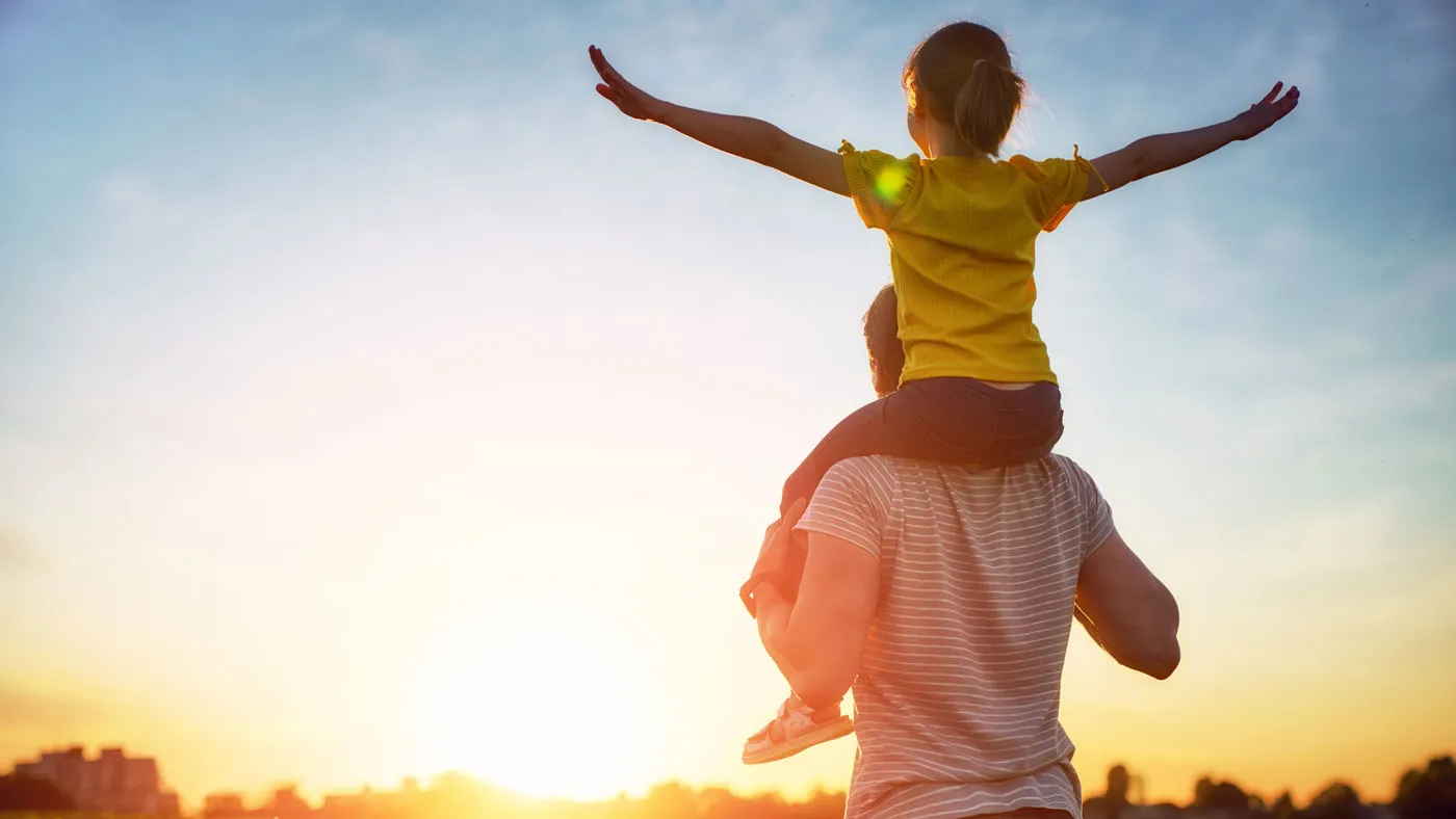 Photo of a girl on the shoulders of her dad